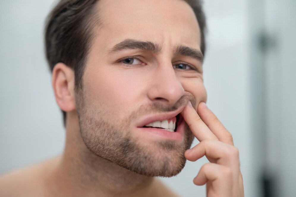 Close-up of inflamed, bleeding gums showing early signs of gum disease during a dental examination.