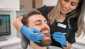 Dentist providing oral care advice to a smiling patient in a dental clinic