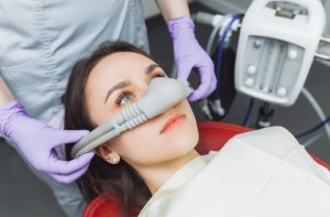 Patient receiving sedation for a dental procedure in a modern clinic setting
